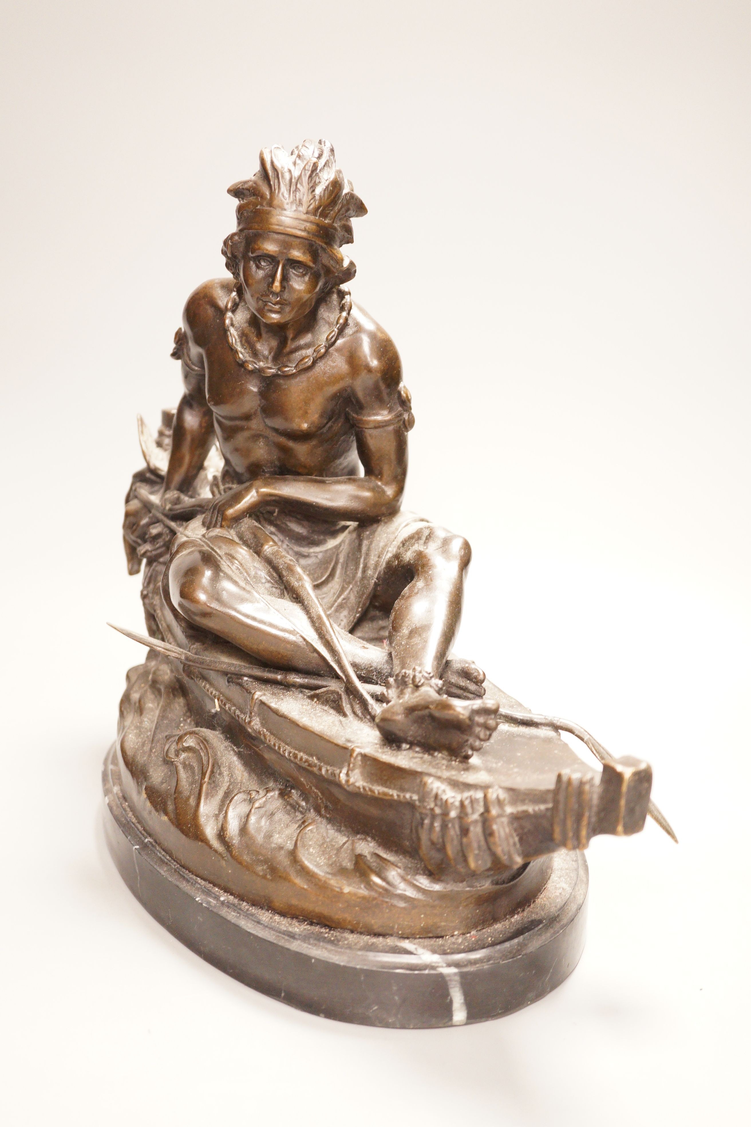 After Duchoiselle, a bronze study of a Native American huntsman in canoe, with impressed mark, on marble base, 30cm tall